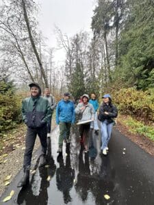 Herrera staff walk in the rain toward the Scriber Lake Park Boardwalk.